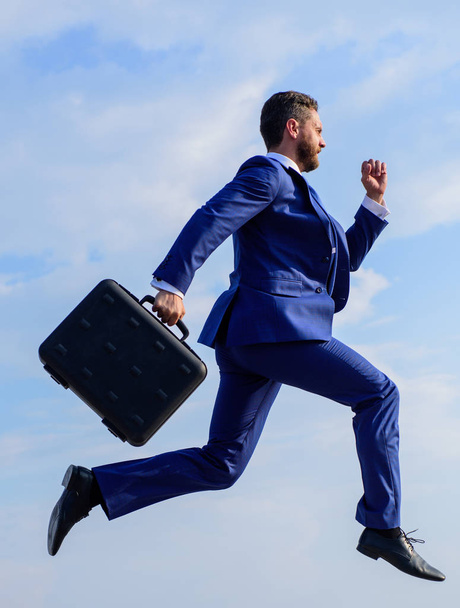 Success in business demands supernatural efforts from entrepreneur personality. Businessman with briefcase jump high motion forward. Supernatural power. Businessman formal suit make effort to succeed - Photo, Image