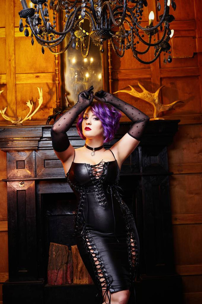 Sensual young woman in leather dress posing - Φωτογραφία, εικόνα