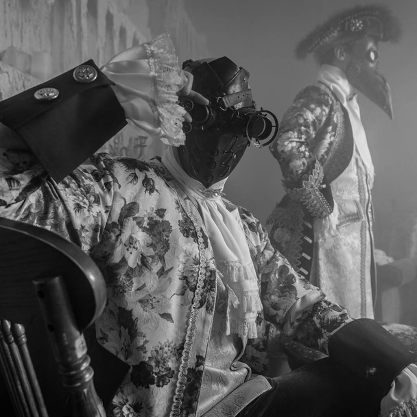 Actors in steam punk masks and antique costumes black-white art photo. - Foto, Bild