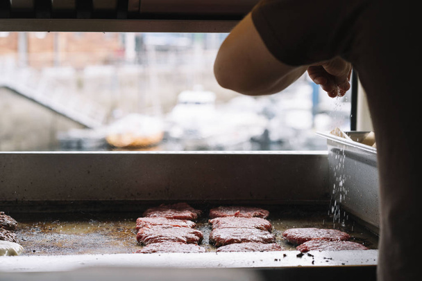Making burgers in a fast food van - Фото, зображення