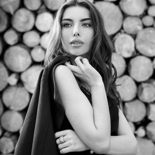 Beautiful women black-white portrait against wooden background. - Fotografie, Obrázek
