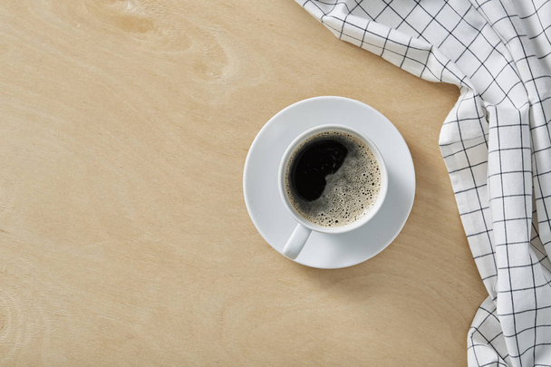 Cup of coffee on wooden table with copy space. Top view. - Фото, зображення