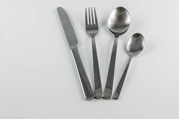 Cutlery with knife, fork, table spoon and little spoon - Fotoğraf, Görsel