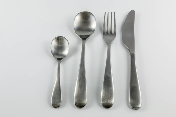 Cutlery with knife, fork, table spoon and little spoon - Photo, Image