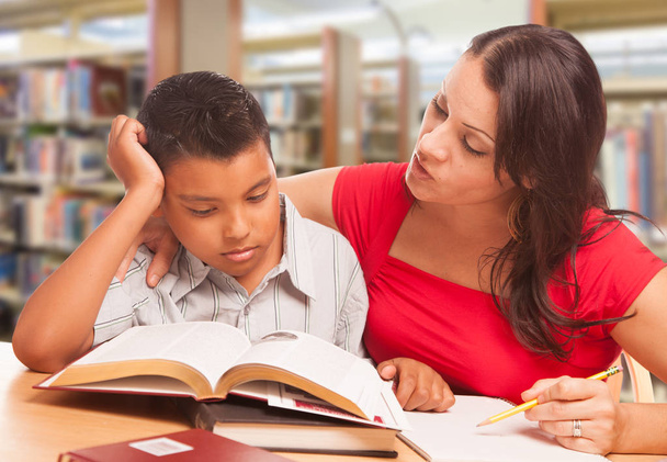 Hispanic Young Boy and Famle Adult Studying At Library. - Photo, Image