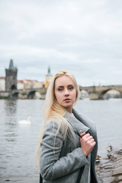 Fashionable blonde with long hair in a coat. - Valokuva, kuva