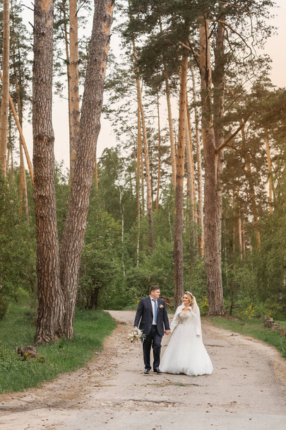 Wedding day. Newlyweds in the forest. Just married - Zdjęcie, obraz