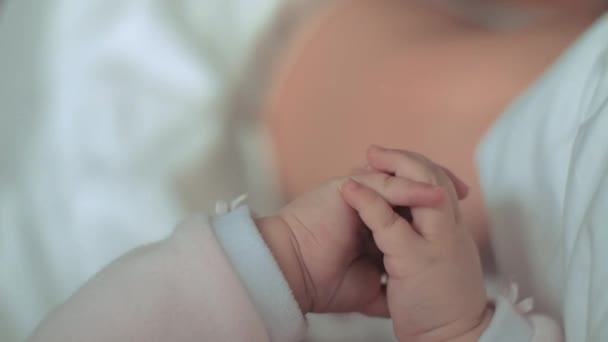 A closeup of a little babys hands - Video