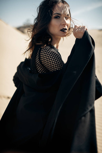 Girl in black at desert  - Photo, image