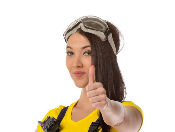 A female construction worker holding an up signal - isolated. - Photo, Image