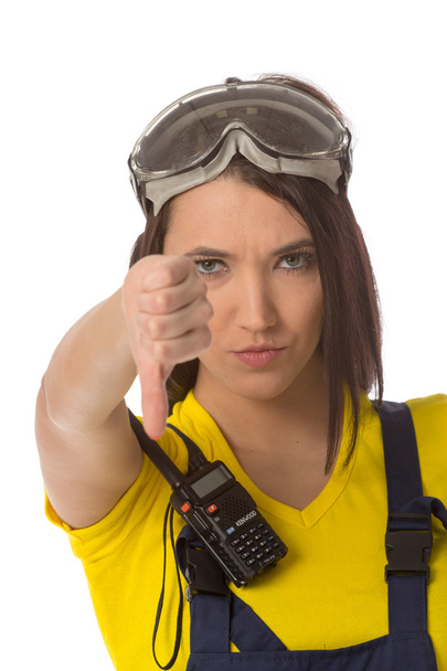 A female construction worker holding a down signal - isolated. - Foto, Bild