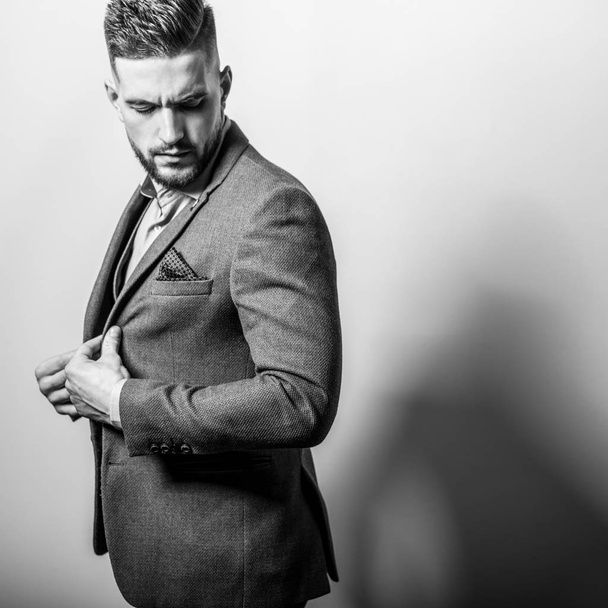 Handsome young elegant man in grey jacket pose against studio background. - Fotoğraf, Görsel