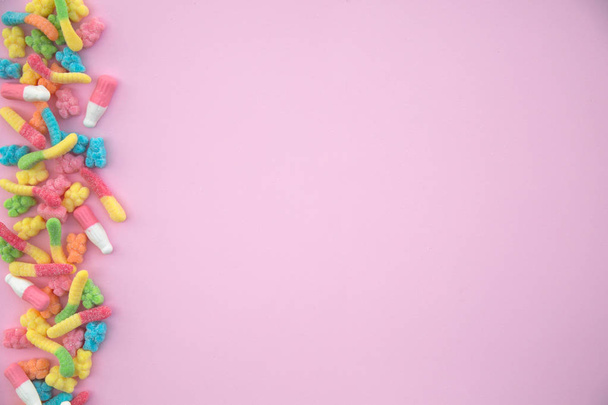 Different gummy candies on a pink background - Foto, Imagen