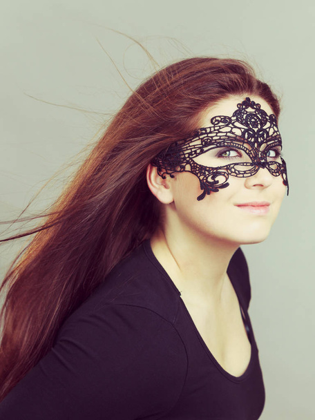Happy pretty mysterious woman wearing black eye lace mask having long brown hair. - Foto, Bild
