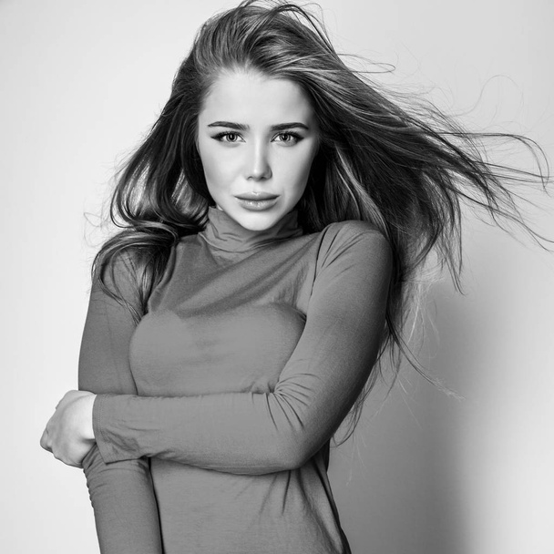 Young sensual model woman pose in studio. Black-white photo. - Фото, изображение