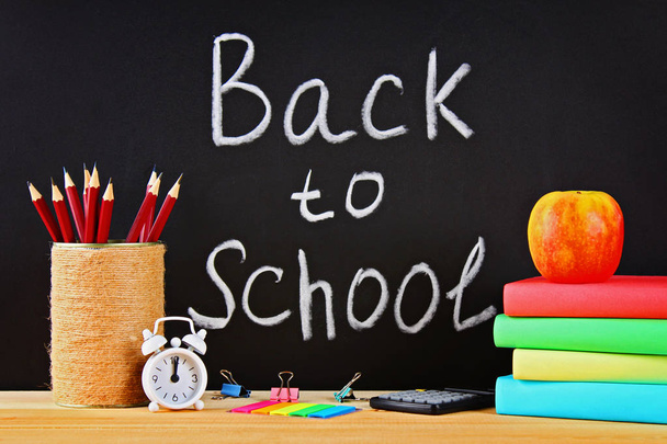 School and office supplies on a black chalkboard background. Back to school - Foto, Imagen