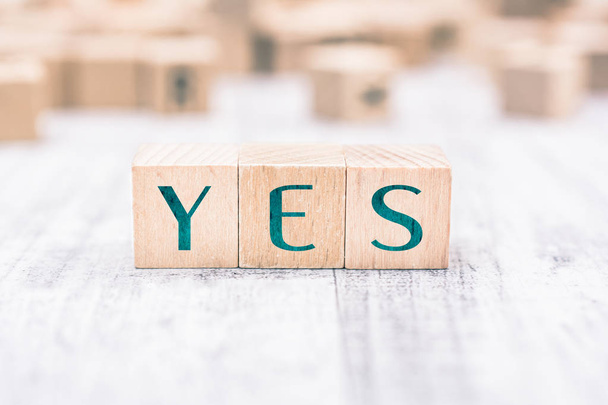 The Word Yes Formed By Wooden Blocks On A White Table - Fotografie, Obrázek