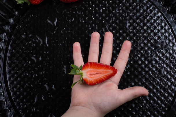 Juicy, sweet and ripe strawberry fruit in hand - Photo, Image