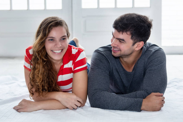 Joking caucasian love couple looking at camera  indoors in new apartment - Foto, immagini