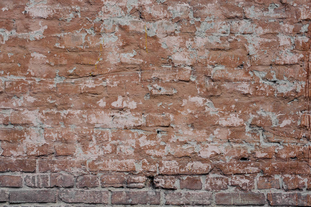 Old dilapidated exterior wall painted in brown color with lines of concrete between rectangle bricks - Fotoğraf, Görsel