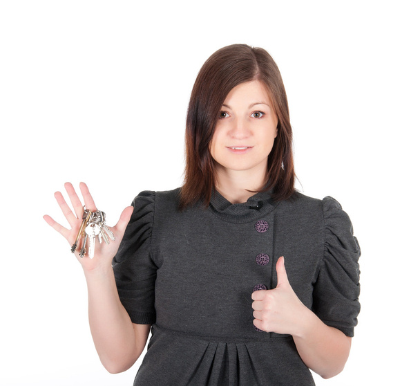 Young beautiful woman showing apartment keys on white background - Foto, Bild