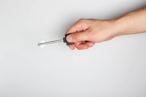 key in hand on a light background - Foto, afbeelding
