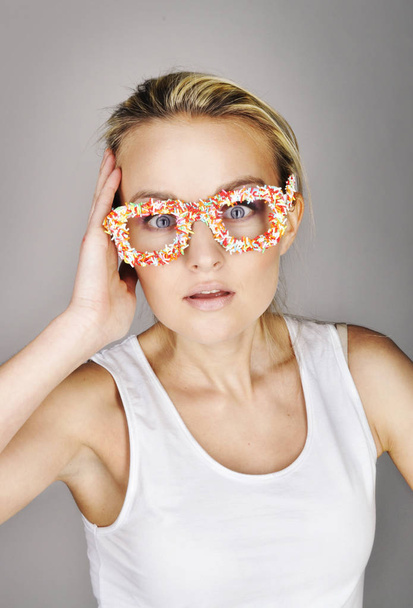 portrait of young blonde girl in funny colorful handmade glasses on studio background.  - Photo, Image