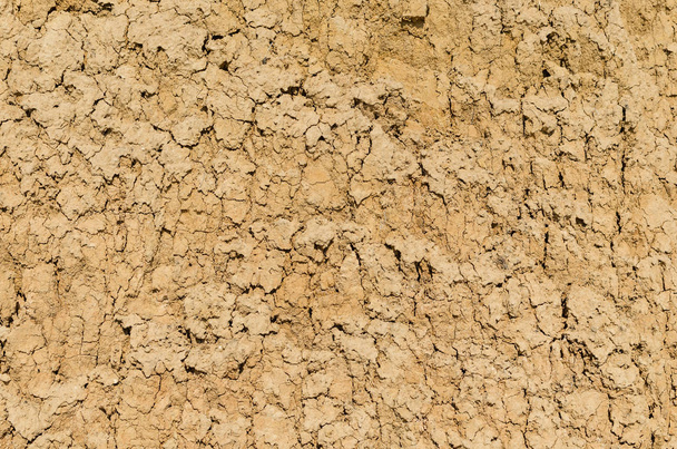 Dry cracked clay with sand, background texture. - Foto, afbeelding