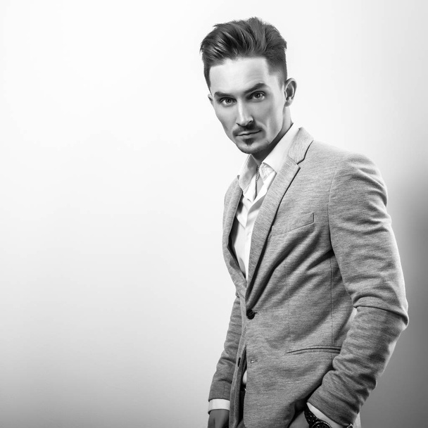 Handsome young elegant man in grey jacket. Black-white photo. - Foto, imagen