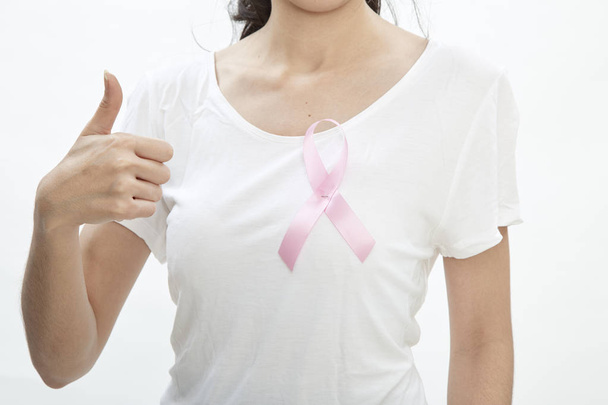 Medicine and breast cancer concept Asian woman with pink cancer ribbon in white background - 写真・画像
