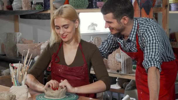 Young couple enjoying working with clay at the pottery workshop - Footage, Video