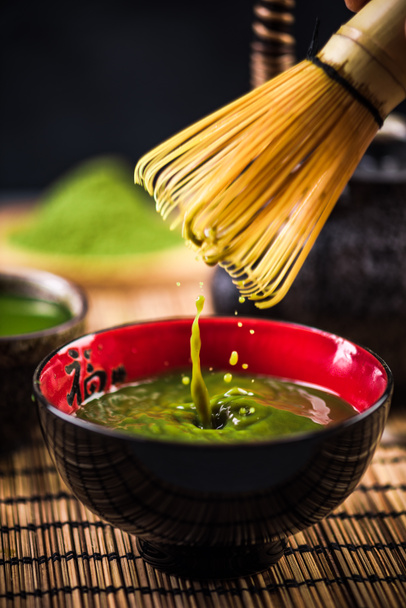 Whisking green Matcha tea in japanese bowl - Photo, Image