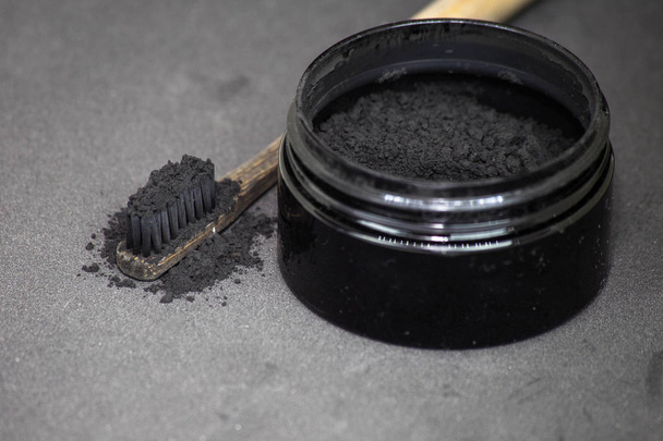 Charcoal on a toothbrush to whiten teeth - Photo, Image
