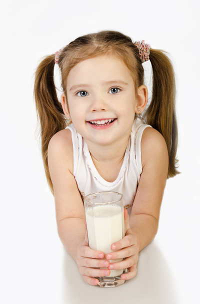 Cute smiling little girl is drinking milk isolated - Photo, Image