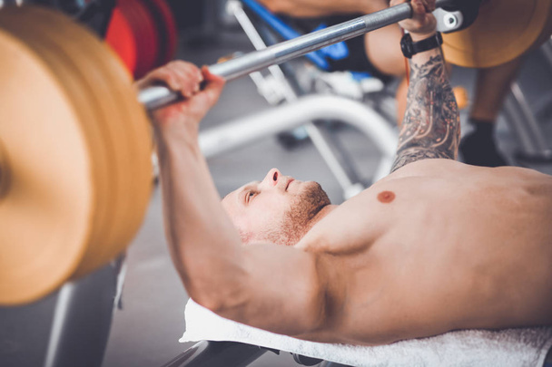 Bodybuilder with barbell in gym. Bodybuilder - Photo, Image