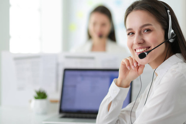 Smiling businesswoman or helpline operator with headset and computer at office - Foto, immagini