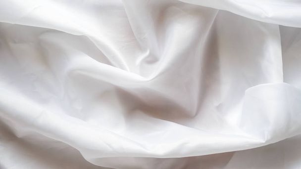 White Synthetic Lining Fabric with Folds. Crumpled Sheet or Clothes Background, - 写真・画像
