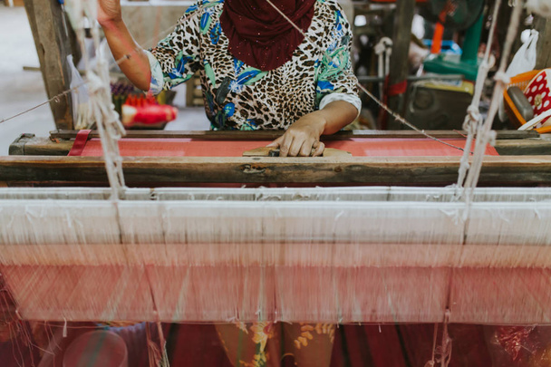 Η υφαίνοντας μηχανή - χρήση για την ύφανση παραδοσιακό ταϊλανδέζικο μετάξι. Σπιτική παραγωγή μετάξι ή ύφασμα στην Ταϊλάνδη. - Φωτογραφία, εικόνα