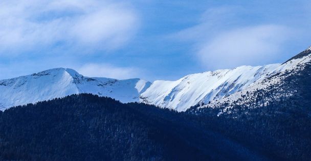 Mountain snow peak, beautiful natural winter backdrop. Ice top of the hill, blue sky background. Alpine landscape. - Photo, image