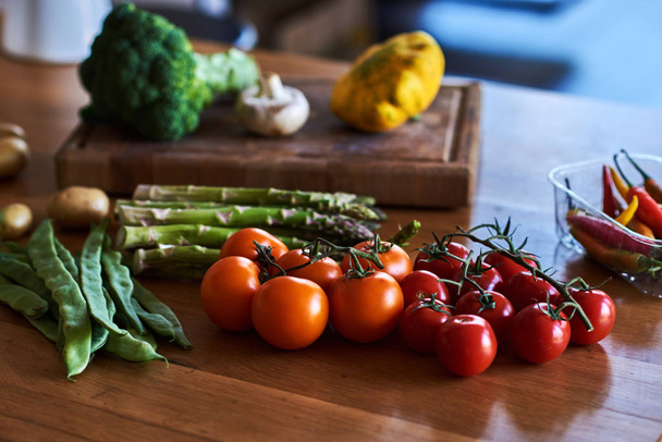 Rustic kitchen table with different fresh farm vegetables. Autumn harvest and healthy organic food concept. - Photo, Image