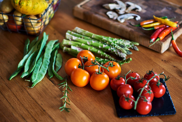 Various fresh vegetables on wooden table. - Фото, изображение