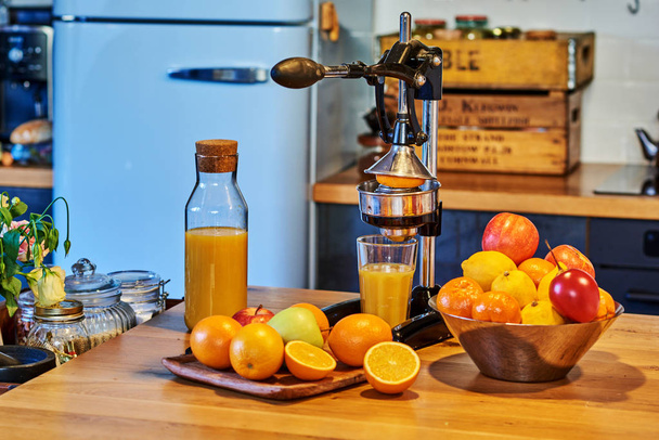 Citrus fruits family slice and manual  juice extractor on wooden table. - Foto, imagen