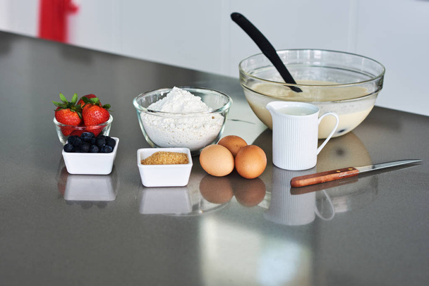 Ingredients with raw eggs, sugar, berry  on kitchen background. - Photo, image