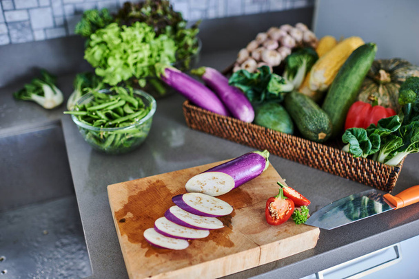 Organic vegetables eggplant on a wooden chopping board. - 写真・画像