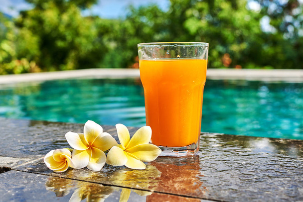 Fresh orange cocktail by the swimming pool. - Fotó, kép