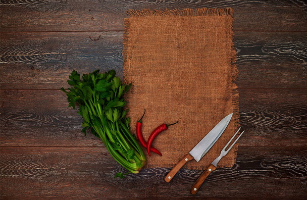 Ideas for the restaurant, dishes in a rustic style on linen with vintage silver knife and fork, betrays a great bunch of greens fresh flavor to any dish - Photo, Image