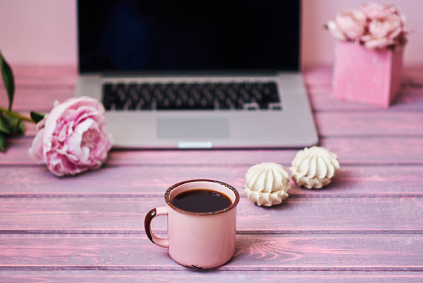 Open laptop  on a vintage wooden table. Portable net-book and cup of hot drink, electronic distance work via internet during coffee break. Feminine workplace. Vintage style. Selective focus. - 写真・画像