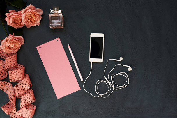 Styled feminine desktop with flowers, paper and smartphone - woman fashion flat lay items on shabby blue background, copy space, top view.  Lifestyle or to announce a celebration or event. - Φωτογραφία, εικόνα