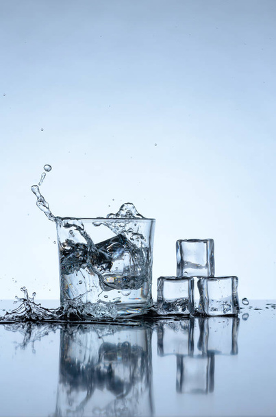 Ice cubes splashing into glass - Fotó, kép