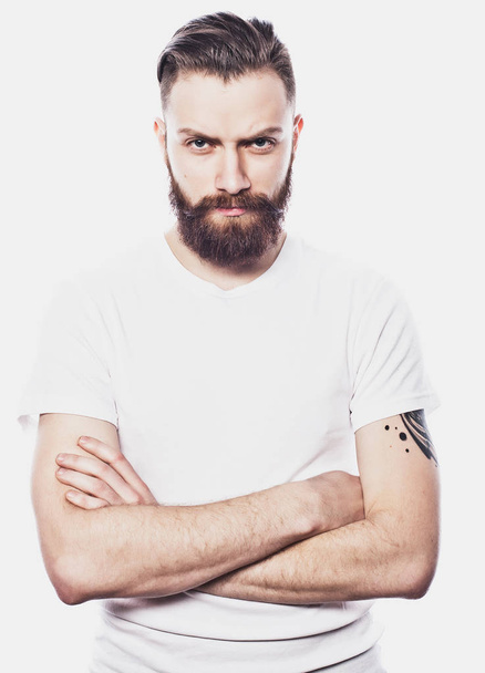 Young bearded man over white background. Lifestyle and people concept. - Фото, зображення